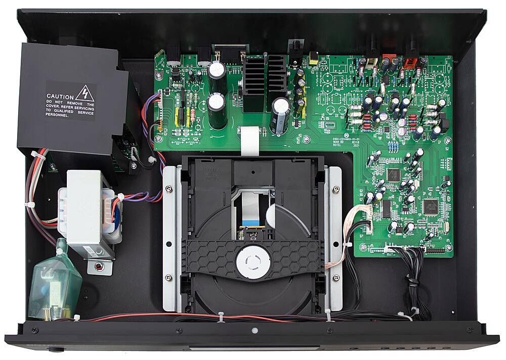 The image shows the inside of an electronic device, possibly a DVD player, with its cover removed. The device is filled with wires and electronic components, including a green circuit board. The image also includes a warning to not remove the cover without qualified personnel, as it could cause damage or pose a safety risk.