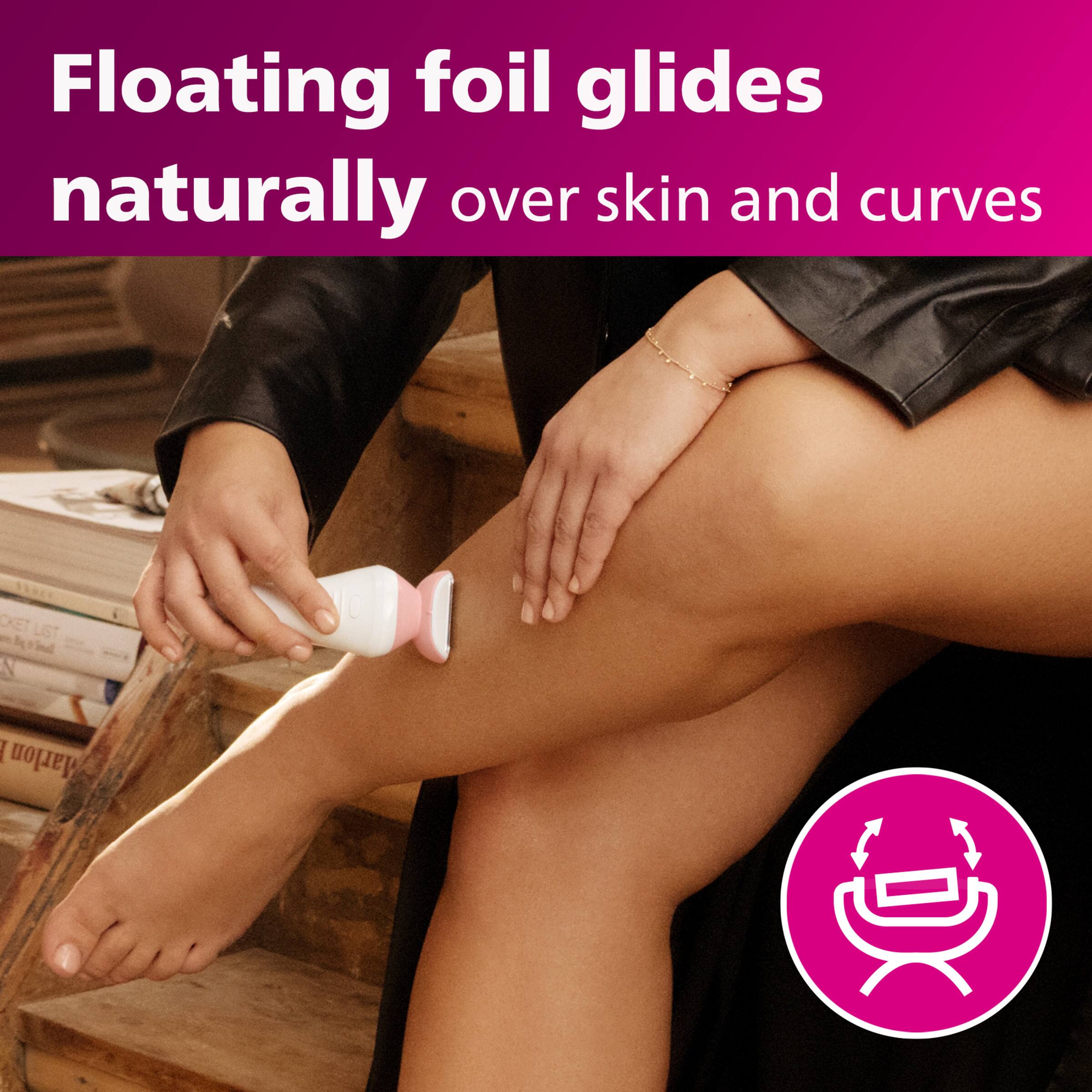 The image features a woman sitting on a staircase, holding a hair trimmer or groomer in her hand. The device is designed to float foil glides naturally over skin and curves, providing a precise and efficient way to trim or groom hair. The woman appears to be demonstrating the use of the device, showcasing its effectiveness and ease of use.