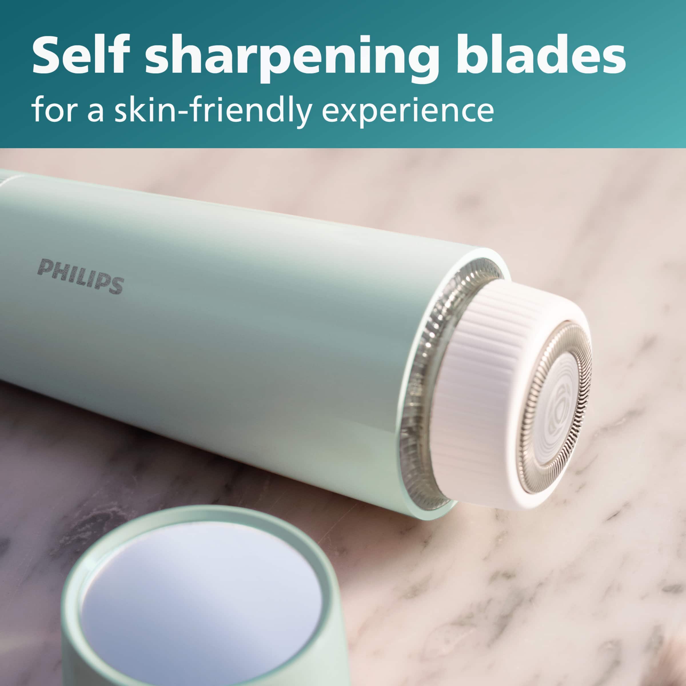The image features a close-up of a Philips shaving device, which is designed to provide a skin-friendly shaving experience. The device has self-sharpening blades that ensure optimal performance and smooth shaving. The shaving device is placed on a marble countertop, and the focus is on the blades, which are essential for a comfortable and precise shaving experience.