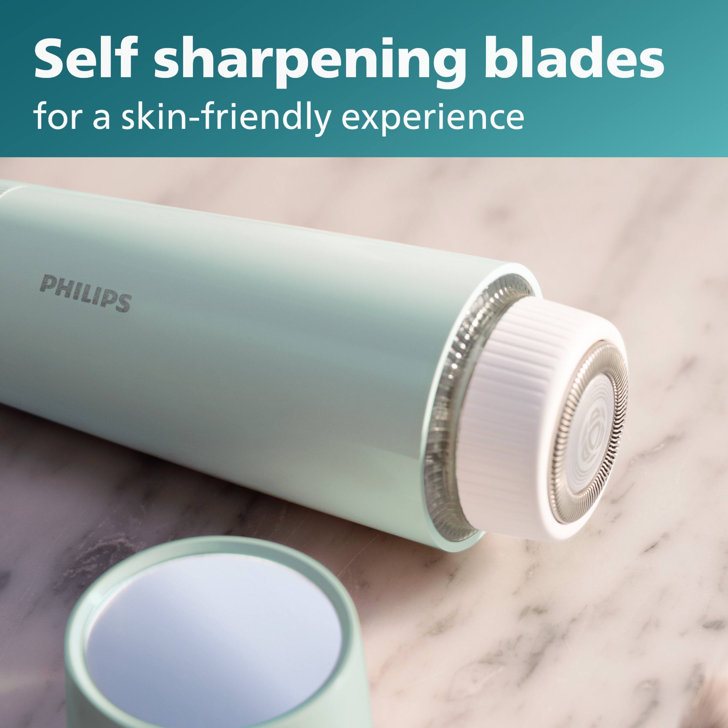 The image features a close-up of a Philips shaving device, which is designed to provide a skin-friendly shaving experience. The device has self-sharpening blades that ensure optimal performance and smooth shaving. The shaving device is placed on a marble countertop, and the focus is on the blades, which are essential for a comfortable and precise shaving experience.