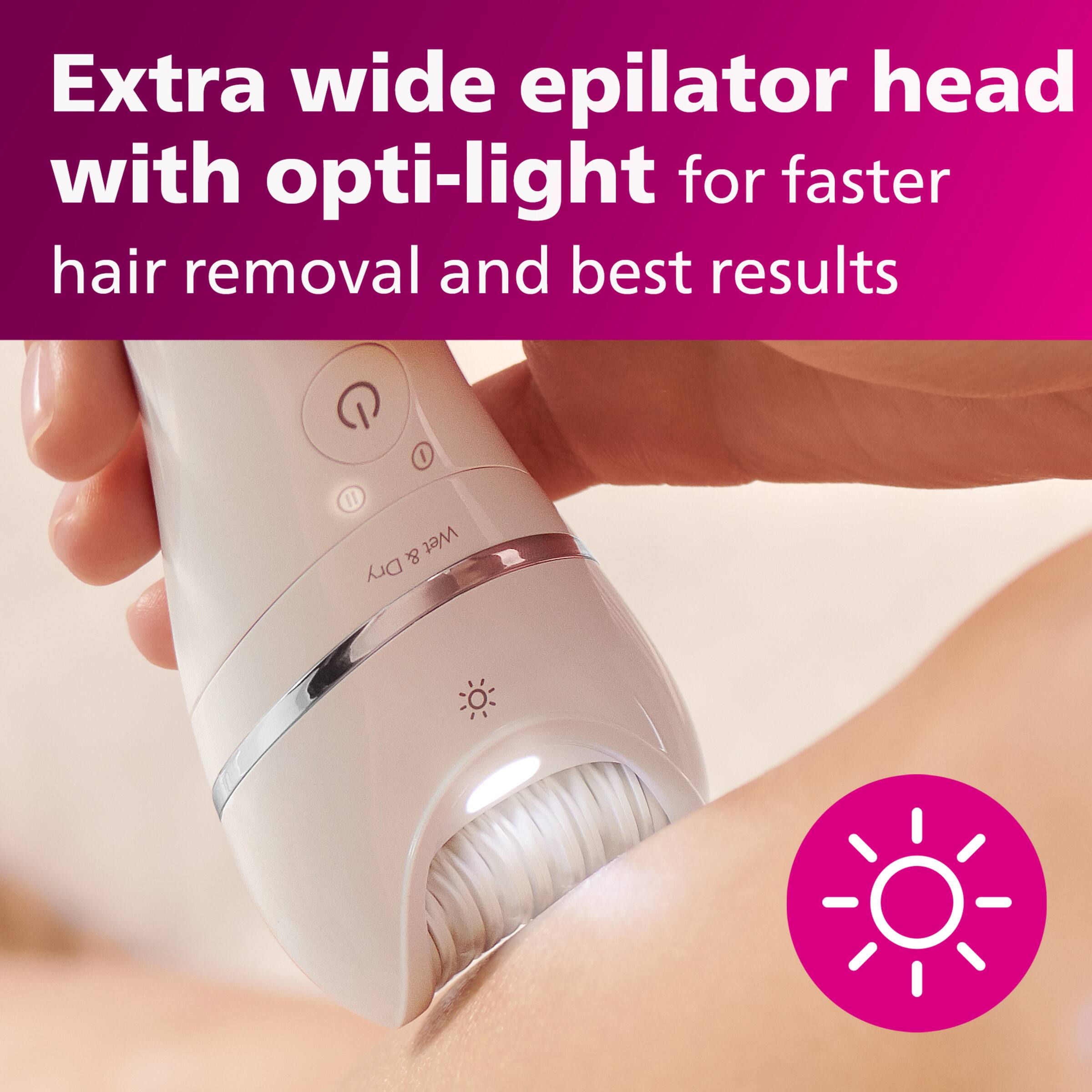 The image shows a person using an extra wide epilator head with opti-light for faster hair removal and best results. The epilator is designed for both wet and dry use, making it convenient for various hair removal needs. The person is holding the epilator close to their skin, which is likely to remove unwanted hair effectively.