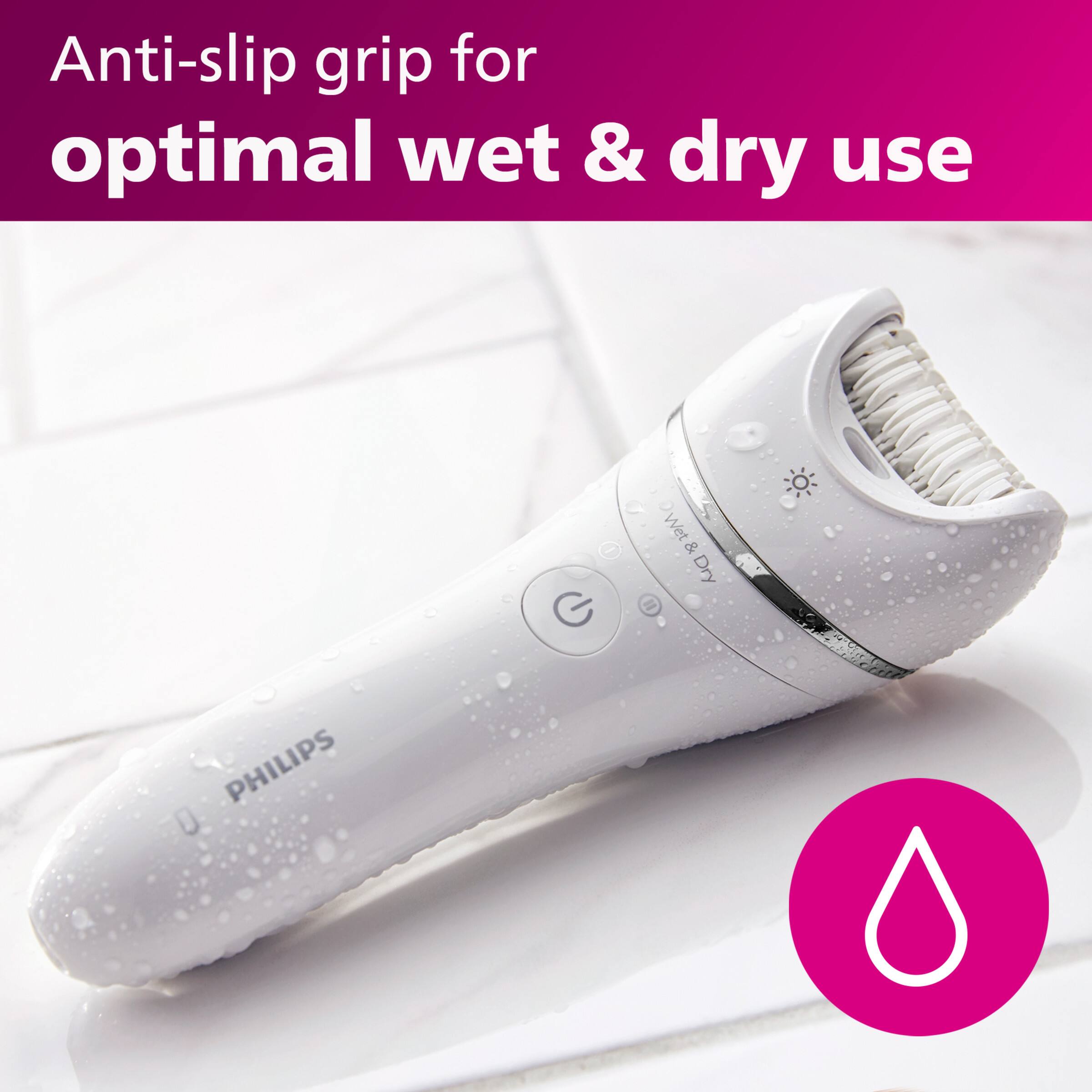 The image features a white electric hair trimmer with an anti-slip grip for optimal wet and dry use. The grip is designed to provide a secure hold on the trimmer, preventing it from slipping during use. The trimmer is made by Philips, a well-known brand in hair care products.