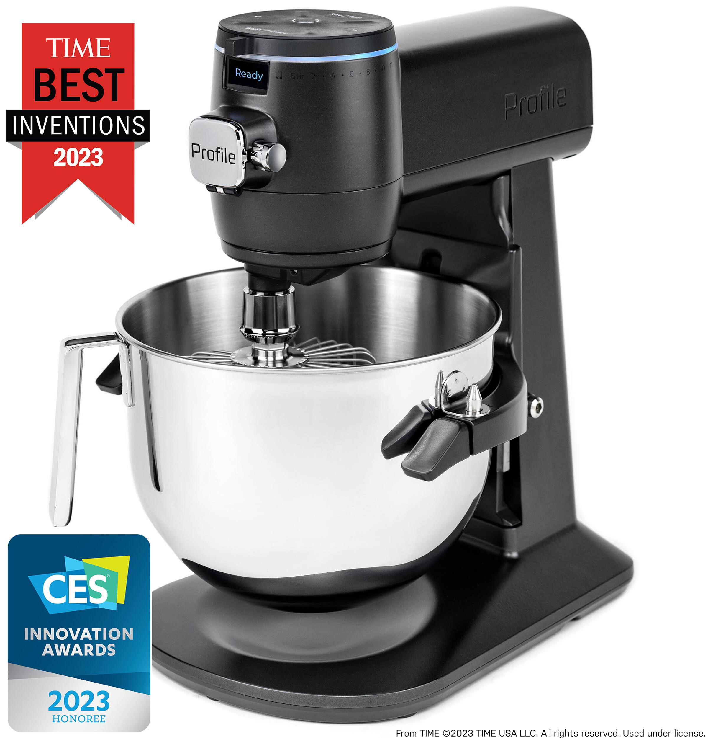 The image features a large silver bowl, which is a part of a mixer. The mixer is designed to make the process of mixing ingredients more efficient and convenient. The mixer has a large bowl, which can hold a significant amount of ingredients, and it is equipped with a powerful motor to ensure thorough mixing. The mixer is a recipient of the CES Innovation Awards 2023, which is a testament to its innovative design and functionality. The image also includes a Time Best Inventions 2023 logo, further emphasizing the mixer's recognition for its innovative features.