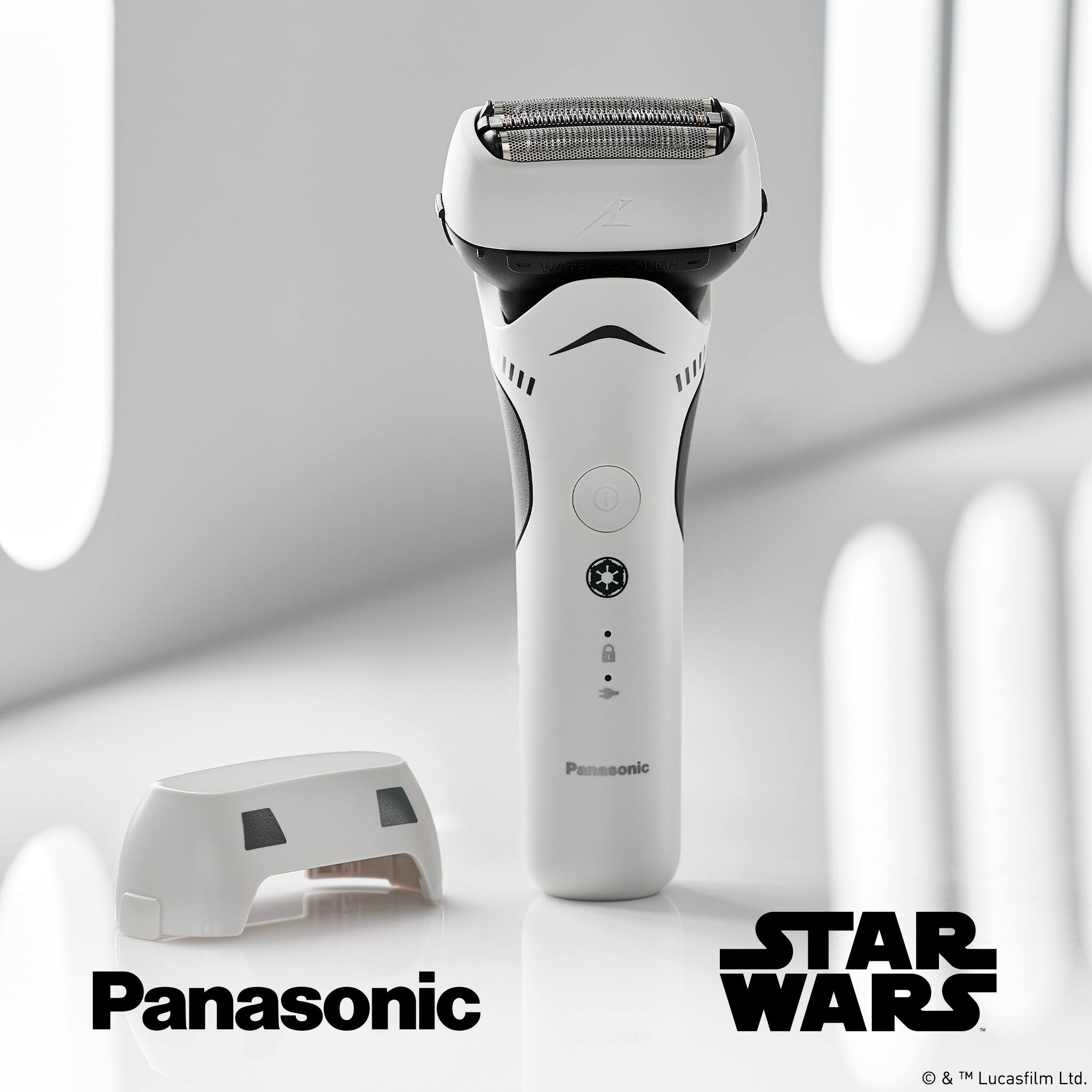 The image features a Panasonic electric shaver with a Star Wars theme, positioned next to a Star Wars-themed shaving head. The shaver is white and black, and it is placed on a white background. The Star Wars logo is visible in the background, adding to the theme of the product.