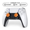 The image features a white and black gaming controller with orange buttons. The controller is designed to enhance the user's gaming experience by providing better grip, movement, and comfort. The orange buttons on the controller stand out and are likely used for specific functions within the game. The controller is likely designed for use with a gaming console, such as the PlayStation or Xbox.