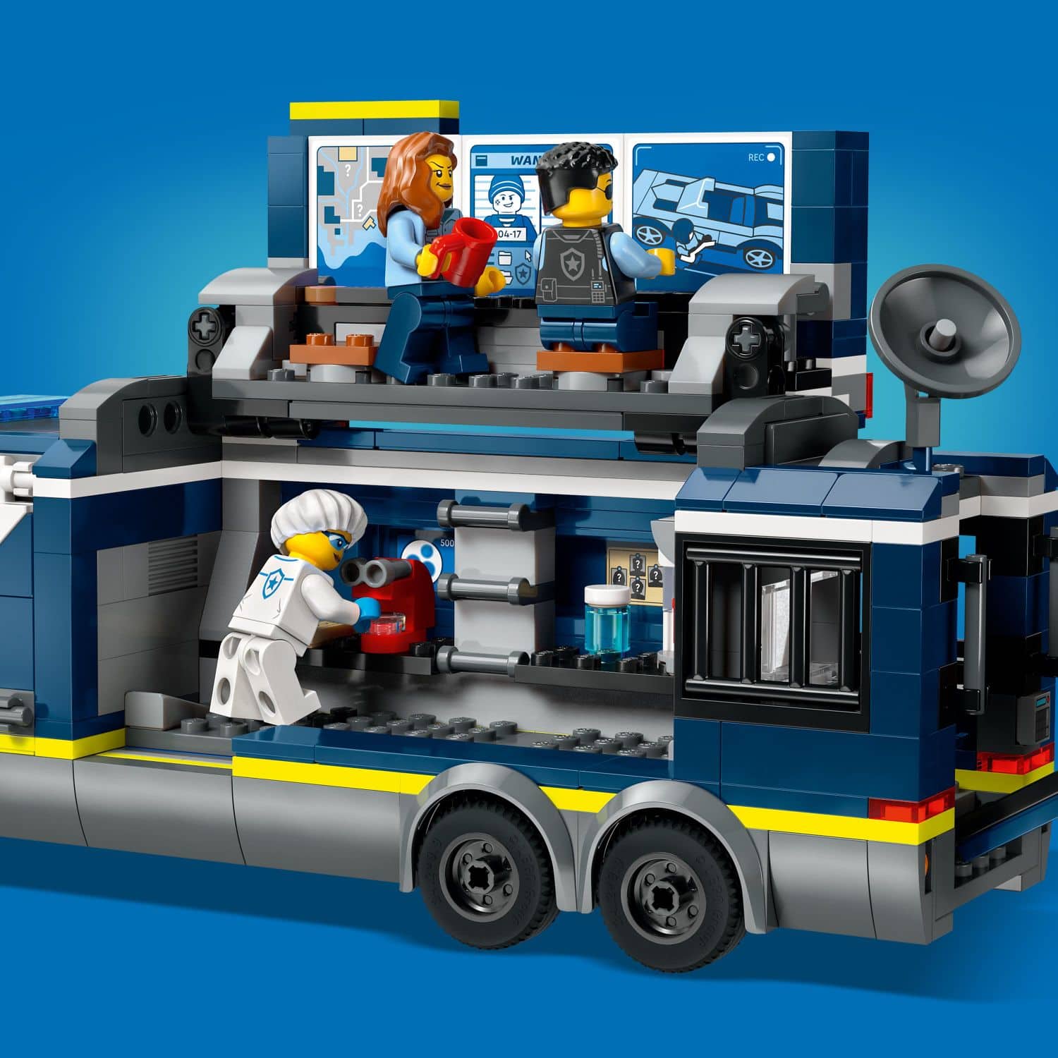 The image features a Lego toy set with a bus and a truck, along with a few Lego people. The bus is the main focus of the scene, and it is accompanied by a truck and a car. The Lego people are scattered around the bus, with some standing close to it and others further away. The scene captures the creativity and fun of playing with Lego toys.