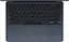 The image features a laptop computer with a black keyboard. The keyboard has a numeric keypad and a set of function keys, including the arrow keys. The keys are arranged in a standard layout, with the letters A to Z on the top row and the numbers 0 to 9 on the bottom row. The laptop is open and ready to use.