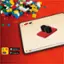 The image features a computer screen with a Lego app open, showcasing a Lego creation on the screen. The app allows users to create and design their own Lego structures, which can then be printed and built using real Lego bricks. The app is available for both iOS and Android devices, as indicated by the presence of an Apple App Store and Google Play Store logo in the image.