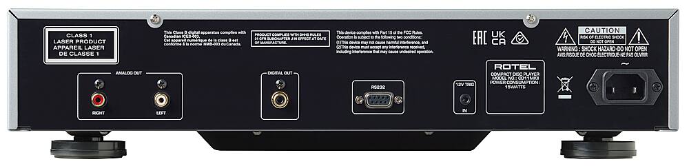 The image features a black electronic device with a warning label on the back. The label indicates that the device complies with Canadian ES-403 Class 1 Laser Apparatus regulations and may not cause harmful interference. The device is also compliant with the FOC Rules Part 15, and it is designed to avoid causing any harmful interference to other devices. The device is a compact disc player, and it has a power consumption of 15 watts. The label also warns against opening the device, as it poses a risk of electric shock.