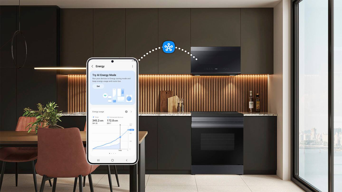 The image features a kitchen with a dining table, chairs, and a cell phone on the table. The cell phone is displaying a message about energy savings. The kitchen also has a TV mounted on the wall, a sink, and an oven. The scene is set in a modern apartment, with a large window providing a view of the city.