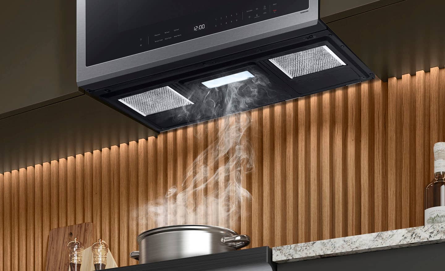 The image shows a kitchen scene with a pot of boiling water on the stove. The pot is placed on the stove, and steam is rising from it. The kitchen also features a microwave above the stove, and a bottle can be seen nearby. The image is taken at 12:00, and the pot is placed on the stove.