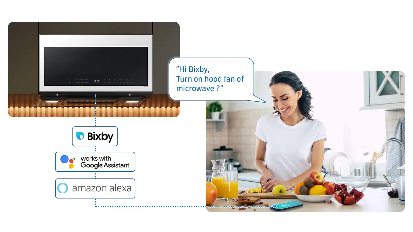 The largest text reads, "Hi Bixby, Turn on hood fan of microwave? Bixby works with Google Assistant, Amazon Alexa." The image features a woman standing in a kitchen, with a microwave and a sink nearby. There are also various fruits, such as apples and oranges, on the countertop.