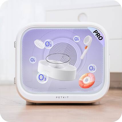 The image shows a small white box with a purple background and a picture of a hair dryer on it. The box is labeled "Petkit" and has a picture of a hair dryer on it. The box also features a picture of a toothbrush, a picture of a donut, and a picture of a cup. The image is likely promoting a hair dryer or a personal grooming device.