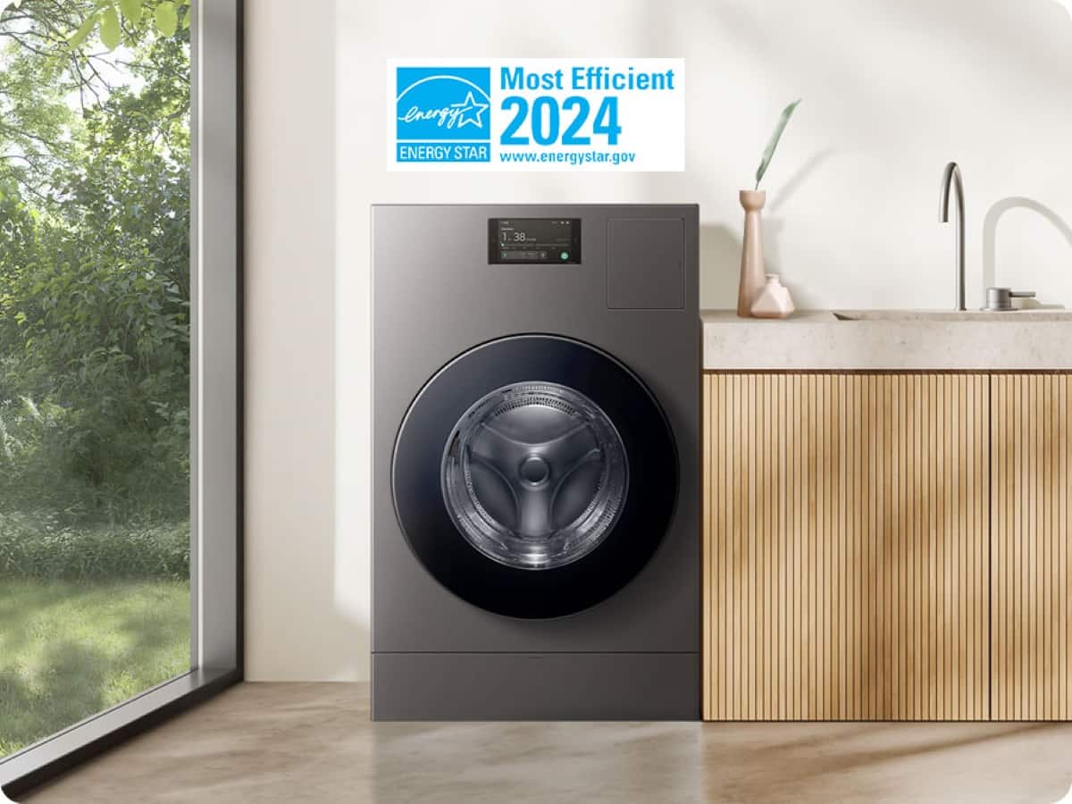The image features a washing machine with a sign above it that reads "Most Efficient Energy 2024 ENERGY STAR." The washing machine is placed in a room with a sink and a window. The sign is likely promoting the energy efficiency of the washing machine, which is an important factor in reducing energy consumption and environmental impact.