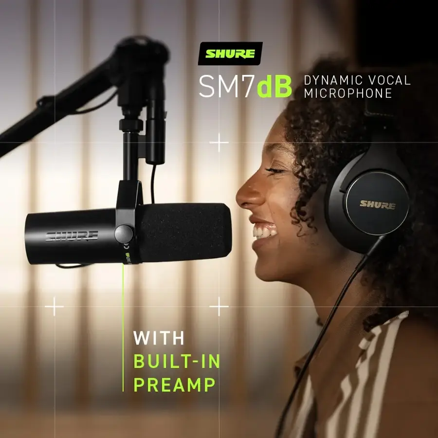 The image features a woman wearing headphones and smiling, with a microphone in front of her. The microphone is a Shure SM7dB dynamic vocal microphone, which is known for its high-quality sound and durability. The headphones are also from Shure, and they are designed to provide clear audio and a comfortable fit. The woman appears to be enjoying her time using these audio devices, possibly for recording or listening to music or podcasts.