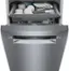 The image features a stainless steel dishwasher with a silver door and a silver handle. The dishwasher is filled with a variety of dishes, including cups, bowls, and spoons. The dishes are neatly arranged inside the dishwasher, ready to be washed. The dishwasher is a built-in model, which is designed to be integrated into the kitchen cabinetry, providing a sleek and space-saving solution for cleaning up after meals.