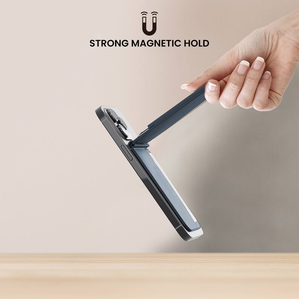 The image shows a person holding a wallet or clutch in their hand, with a strong magnetic hold keeping it securely in place. The wallet appears to be made of leather, and the magnetic hold is designed to keep it attached to a metal surface, such as a refrigerator or a piece of jewelry. The person's hand is positioned over the wallet, showcasing the strength of the magnetic hold.