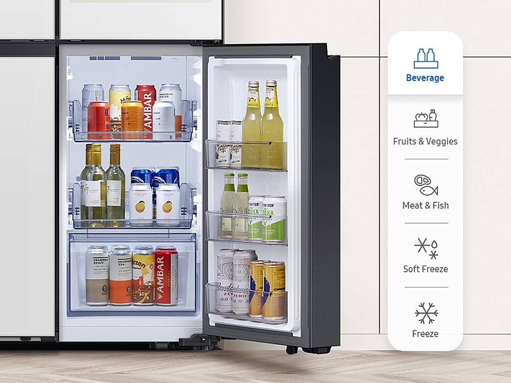 The image shows a large refrigerator with its door open, revealing a variety of food and drinks inside. The refrigerator is filled with numerous bottles, including both alcoholic and non-alcoholic beverages. There are also several cups and a bowl placed inside the fridge. The refrigerator is organized with a dedicated section for fruits and vegetables, as well as a separate compartment for meat and fish. The refrigerator is designed to provide easy access to all the items stored inside, making it a convenient and functional appliance for everyday use.