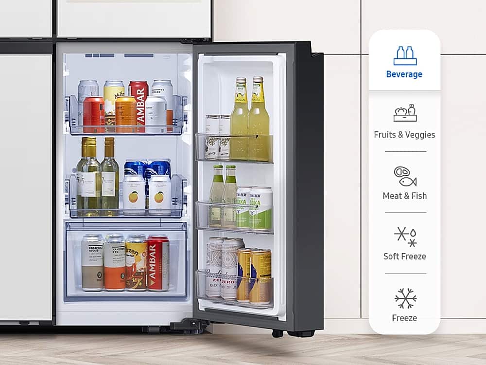 The image shows a large refrigerator with its door open, revealing a variety of food and drinks inside. The refrigerator is filled with numerous bottles, including both alcoholic and non-alcoholic beverages. There are also several cups and a bowl placed inside the fridge. The refrigerator is organized with a dedicated section for fruits and vegetables, as well as a separate compartment for meat and fish. The refrigerator is designed to provide easy access to all the items stored inside, making it a convenient and functional appliance for everyday use.