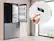 The image features a Samsung refrigerator with a large text that reads "Fridge 37 OK." The refrigerator is placed in a kitchen, and there is a window nearby. The refrigerator is empty, and a hand is seen interacting with the digital display, possibly adjusting the temperature or settings. The scene showcases a modern kitchen with a focus on the Samsung appliance.