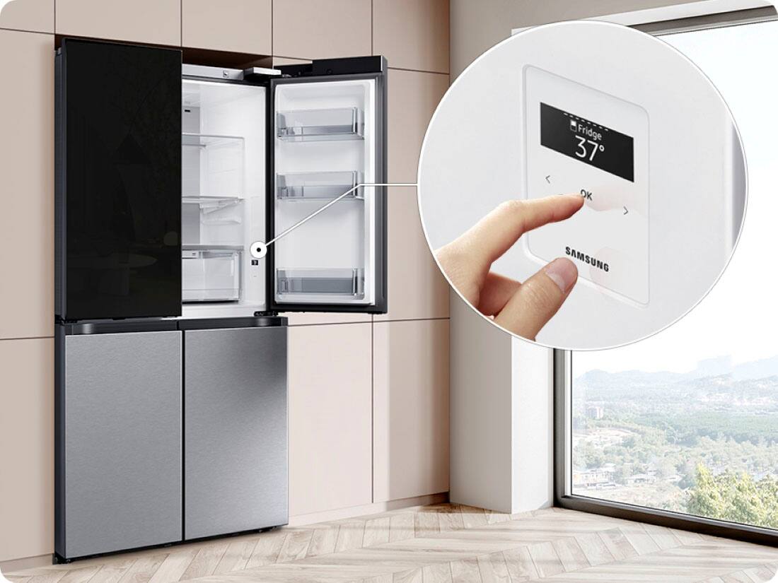 The image features a Samsung refrigerator with a large text that reads "Fridge 37 OK." The refrigerator is placed in a kitchen, and there is a window nearby. The refrigerator is empty, and a hand is seen interacting with the digital display, possibly adjusting the temperature or settings. The scene showcases a modern kitchen with a focus on the Samsung appliance.