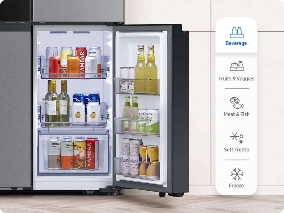 The image features a refrigerator with its door open, revealing a variety of drinks and food items inside. There are several bottles of beverages, including a bottle of wine, and a few bottles of juice. The refrigerator also contains a few fruits, such as apples and oranges. The refrigerator is equipped with a freezer, which is located on the bottom right side. The refrigerator is placed in a kitchen setting, with a tile floor visible in the background.