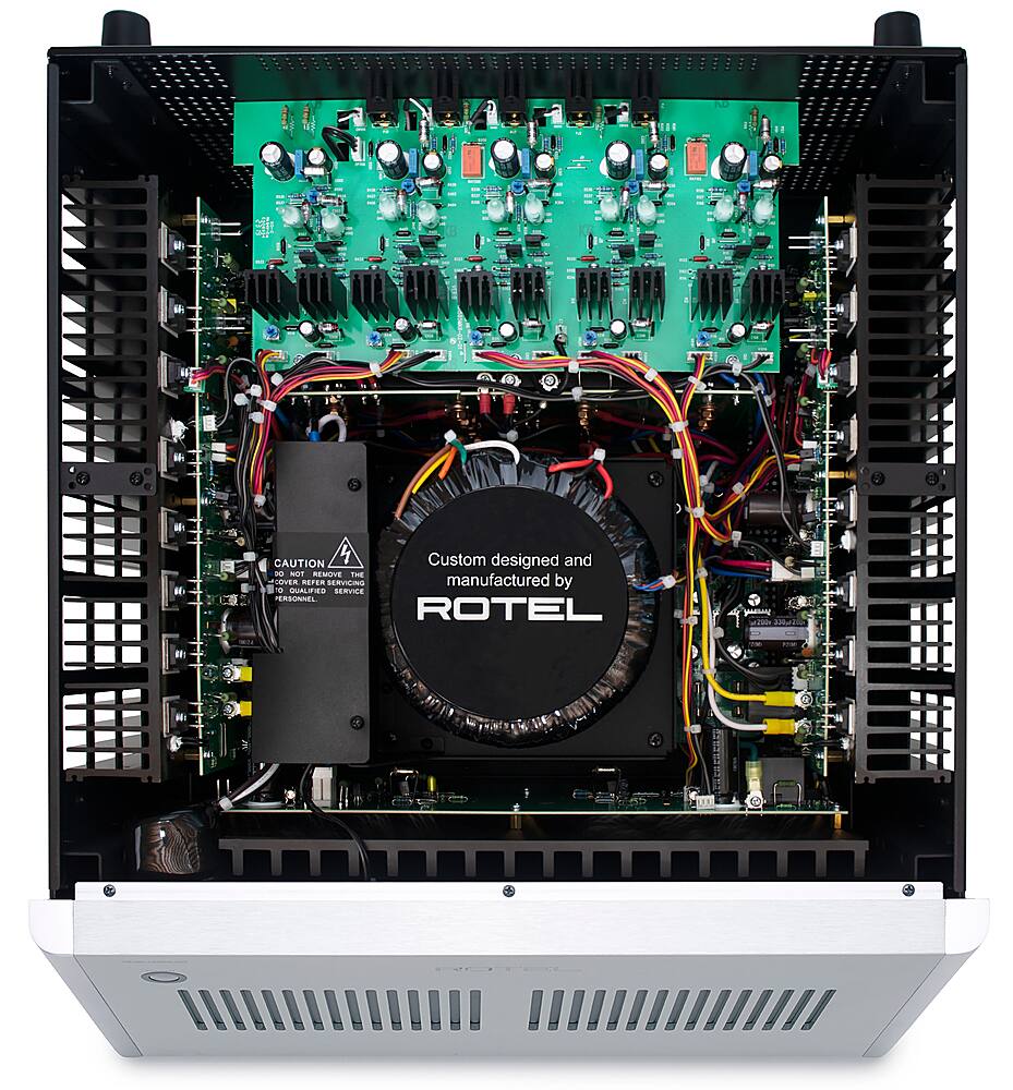 The image shows a custom designed and manufactured electronic device by Rotel. The device is designed for use with a computer and features a large number of wires and connections. The device is housed in a white case and is open, revealing the internal components. The wires are colorful and are arranged in various patterns, indicating the complexity of the device's design. The device is likely used for audio or video processing, given the number of connections and the presence of a power supply.
