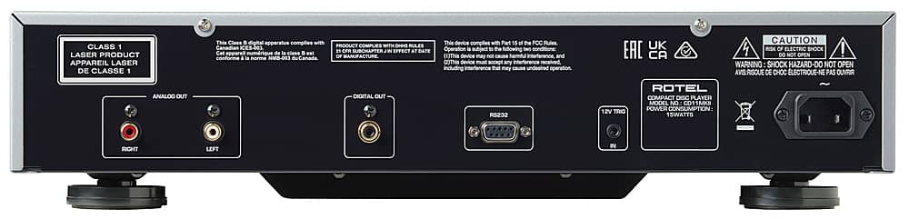 The image features a black electronic device with a warning label on the back. The label indicates that the device complies with Canadian ES-403 Class 1 Laser Apparatus regulations and may not cause harmful interference. The device is also compliant with the FOC Rules Part 15, and it is designed to avoid causing any harmful interference to other devices. The device is a compact disc player, and it has a power consumption of 15 watts. The label also warns against opening the device, as it poses a risk of electric shock.