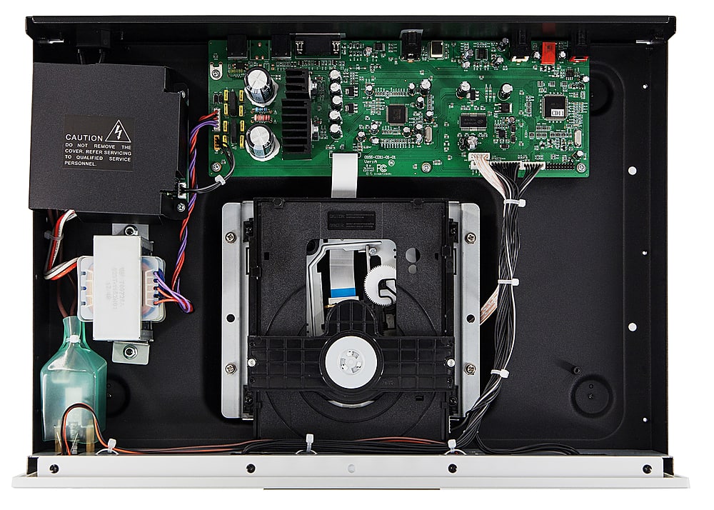 The text on the image reads: "CAUTION: DO NOT REMOVE THE COVER. REFER TO SERVICING 10 QUALIFIED SERVICE PERSONNEL." This indicates that the computer components should not be tampered with or removed without proper knowledge and expertise. It is important to follow these guidelines to avoid damage to the equipment and ensure its proper functioning.