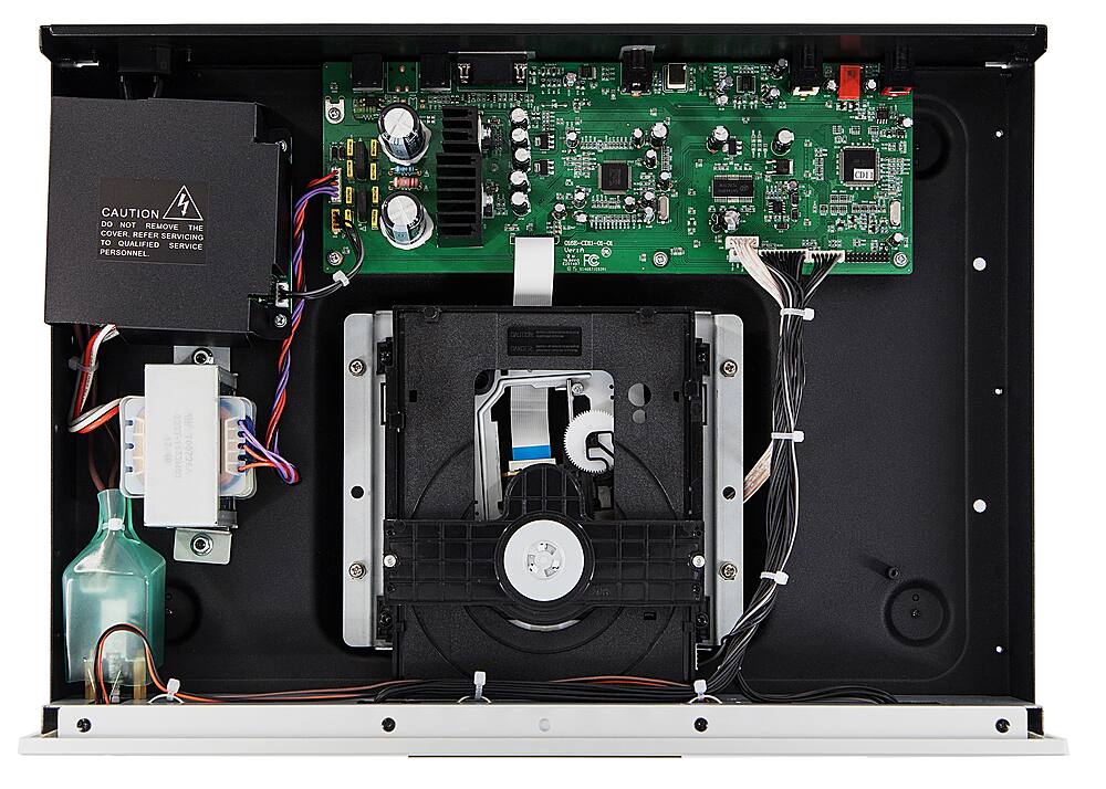 The text on the image reads: "CAUTION: DO NOT REMOVE THE COVER. REFER TO SERVICING 10 QUALIFIED SERVICE PERSONNEL." This indicates that the computer components should not be tampered with or removed without proper knowledge and expertise. It is important to follow these guidelines to avoid damage to the equipment and ensure its proper functioning.