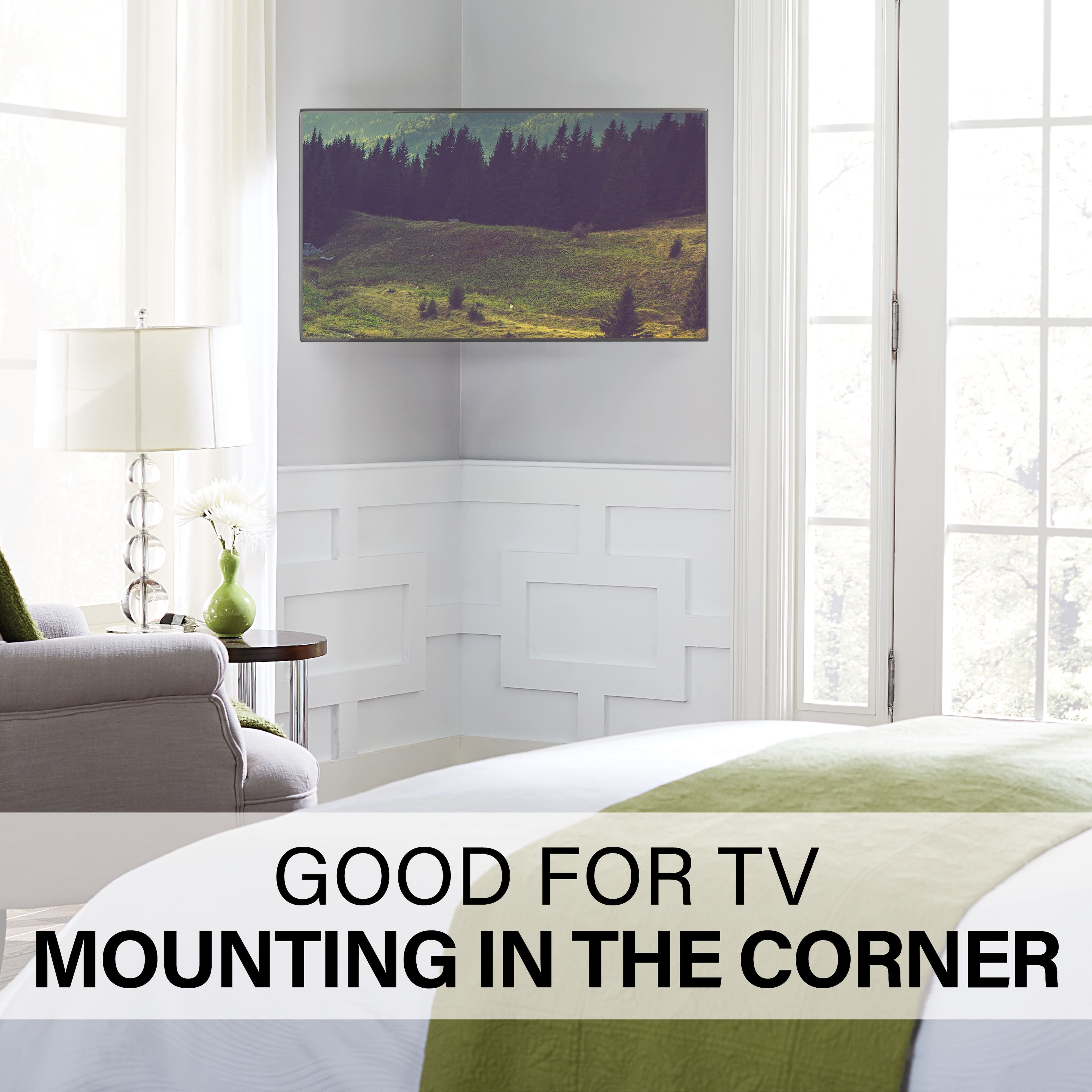 The image shows a bedroom with a large flat-screen TV mounted on the wall near the corner of the room. The TV is positioned above a bed, and there is a chair nearby. The room also features a window, providing natural light to the space. The overall setting suggests that the TV mounting in the corner is a good choice for this room, as it maximizes the use of available space and creates a comfortable viewing experience.