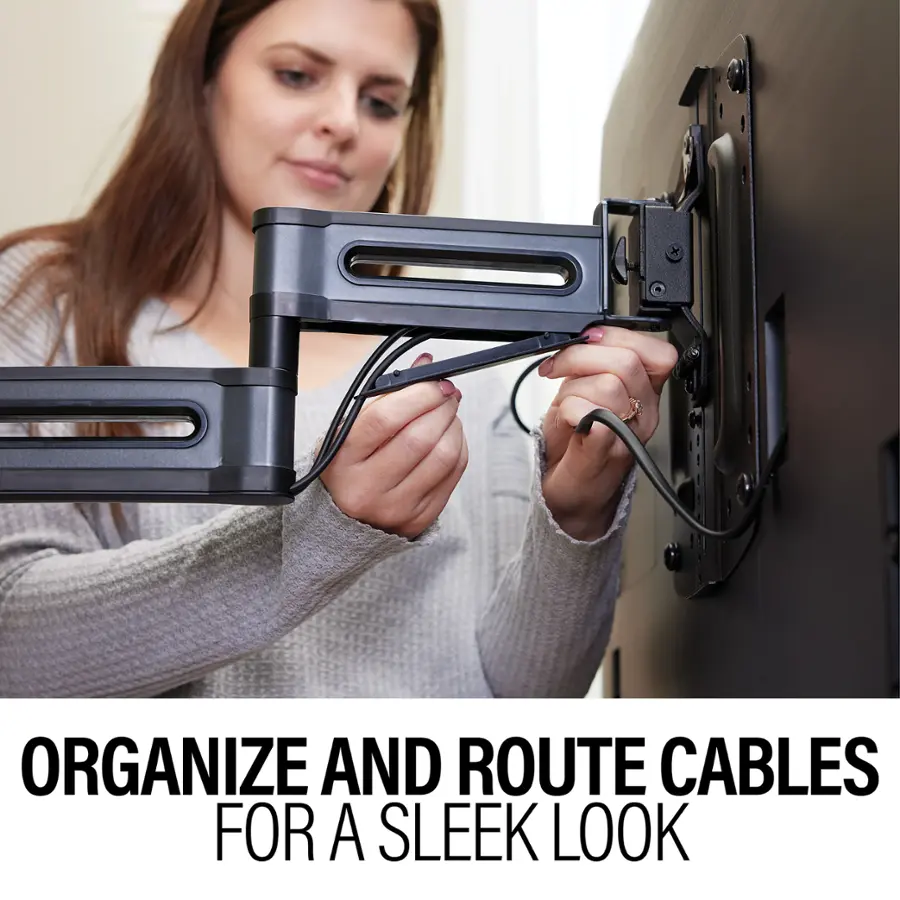 The image features a woman with brown hair, who is organizing and routing cables for a sleek look. She is using a cable management system to neatly arrange the cables in a way that is visually appealing and functional. The woman is focused on her task, ensuring that the cables are properly routed and secured. This demonstrates the importance of cable management in creating a tidy and organized living or working space.