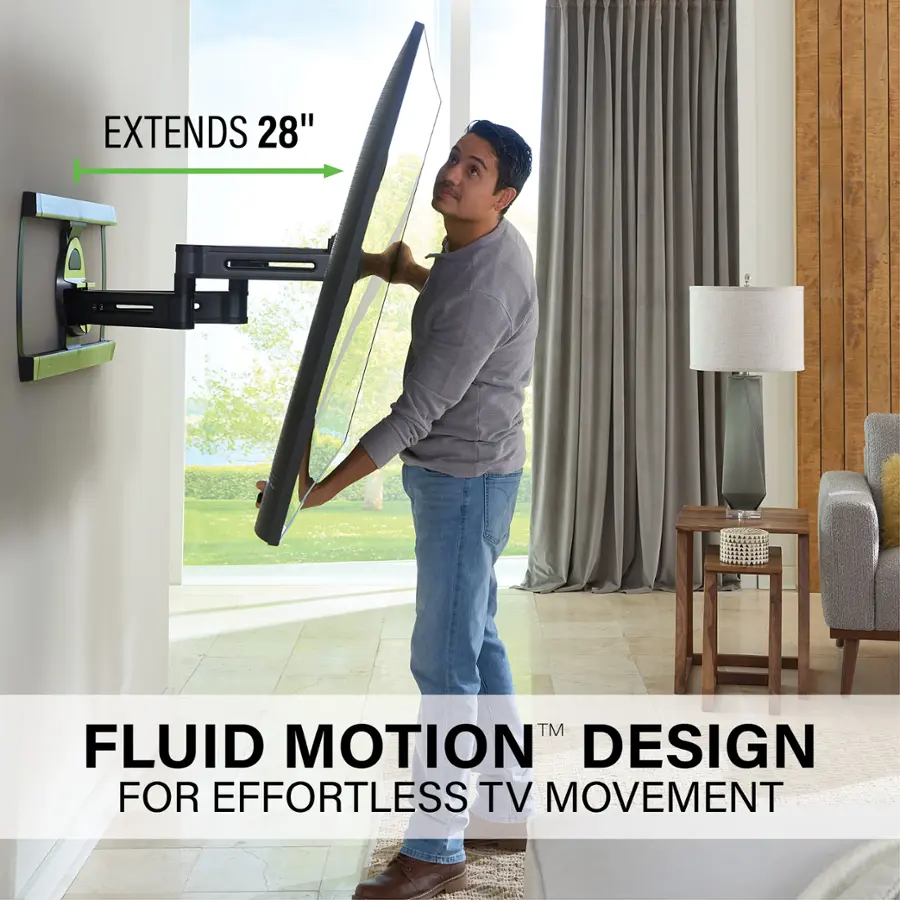 The image features a man standing in a living room, holding a large TV screen. He is positioned in front of a window, and the TV screen appears to be quite large, extending 28 inches. The man is likely demonstrating the Fluid Motion Design for effortless TV movement, which allows for easy and smooth repositioning of the TV screen without the need for additional assistance. The living room is furnished with a couch and a chair, creating a comfortable and inviting atmosphere for entertainment and relaxation.