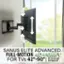 The image features a large flat screen TV mounted on the wall, with a Sanus Elite Advanced Full-Motion 4D+Shift TV mount. The TV is positioned in front of a window, providing a view of the outdoors. The mount is designed to support TVs ranging from 42" to 90" in size and can hold up to 125 lbs. The extended arm of the mount allows for additional flexibility in positioning the TV on the wall.
