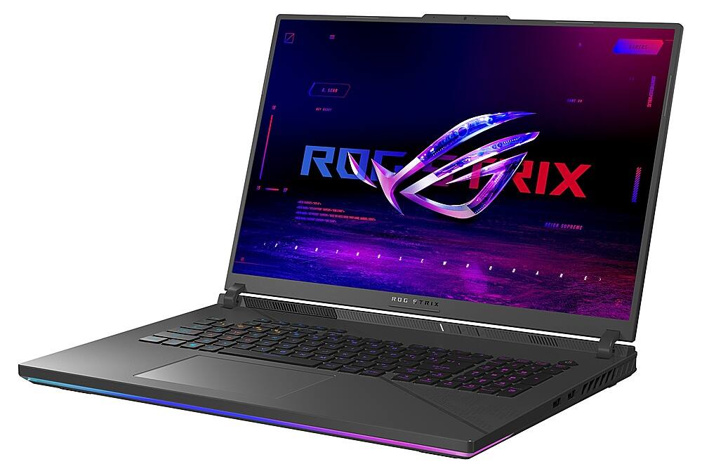 The image features a laptop computer with a purple background and a logo for ROG Strix. The laptop is open, displaying the ROG Strix logo on the screen.