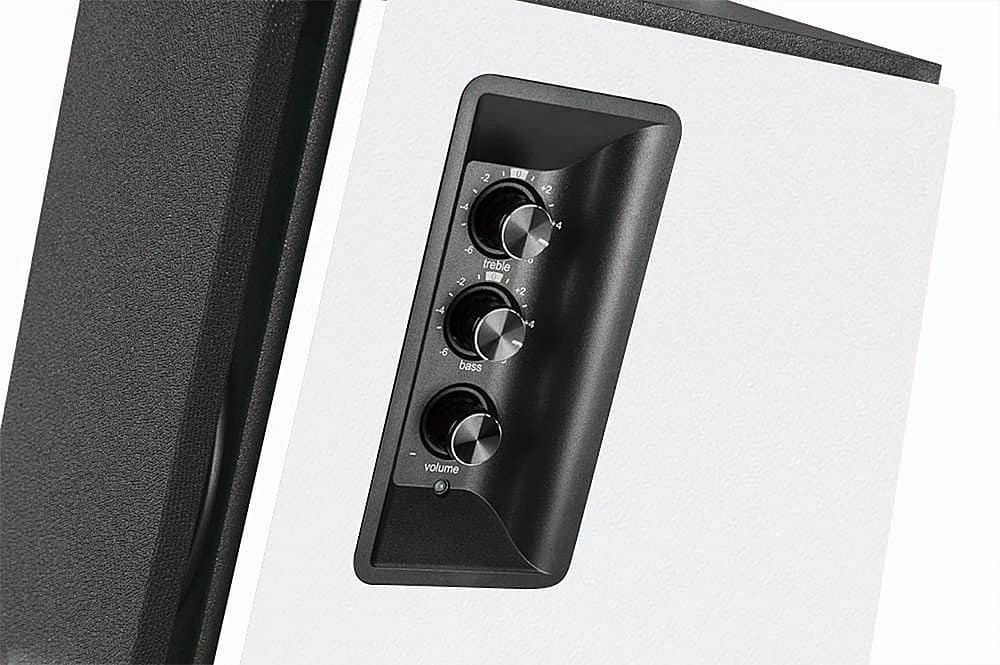 The text on the image reads: "2 - A - I 10 I 2 4 a treble 2 07 - +2 4 4 -6 bass - volume." This text is grouped and corrected as follows:
"2 - A - I 10 I 2 4 a treble 2 07 - +2 4 4 -6 bass - volume."
The corrected text is a description of the controls on the device, indicating that there are two treble controls, two bass controls, and a volume control.