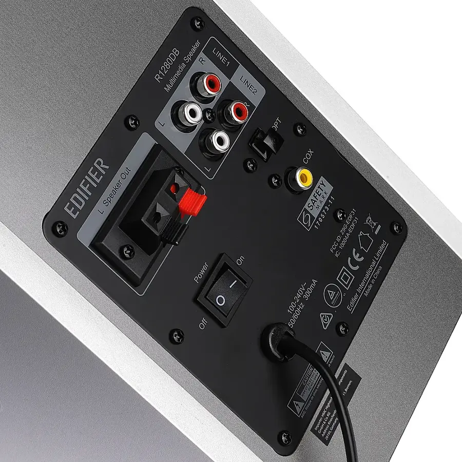 The text on the image reads: "Out EDIFIER Speaker Speaker LINE1 R R1280DB Multimedia LINE2 On Power I Off OPT COX SAFETY MARK RK 73 11 1705 EDF31 EDF31 FCCID: 10004A-EDF31 10004A Limited IC: CE tional China 300mA International Made S E 100-240V- 50/60Hz Edifier! po pontoels imponent ac fmmec Highiey? Sai NMC 8 Cmoar Addes J8TH 2819Germany."