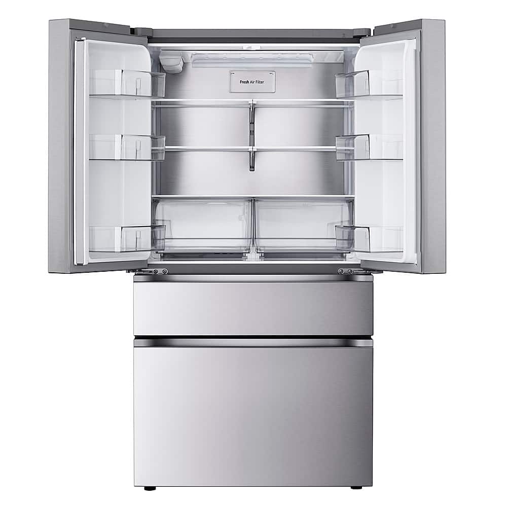 The image features a large, stainless steel refrigerator with a freezer on the bottom. The refrigerator is empty, with no food or drinks visible inside. The refrigerator is standing upright, and the door is open, revealing the empty interior.