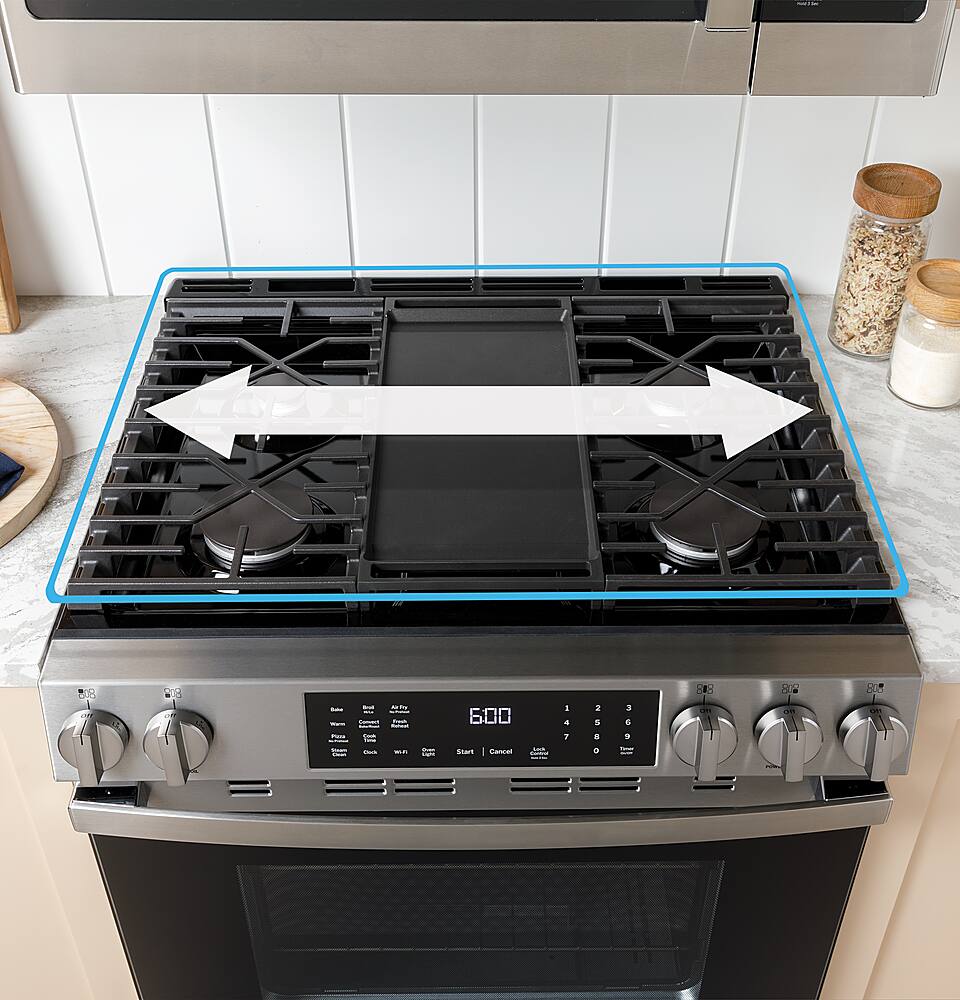 The image features a stove with a digital display showing the time of 6:00. The stove has a black top and a silver bottom. There is a white bowl on the countertop next to the stove.