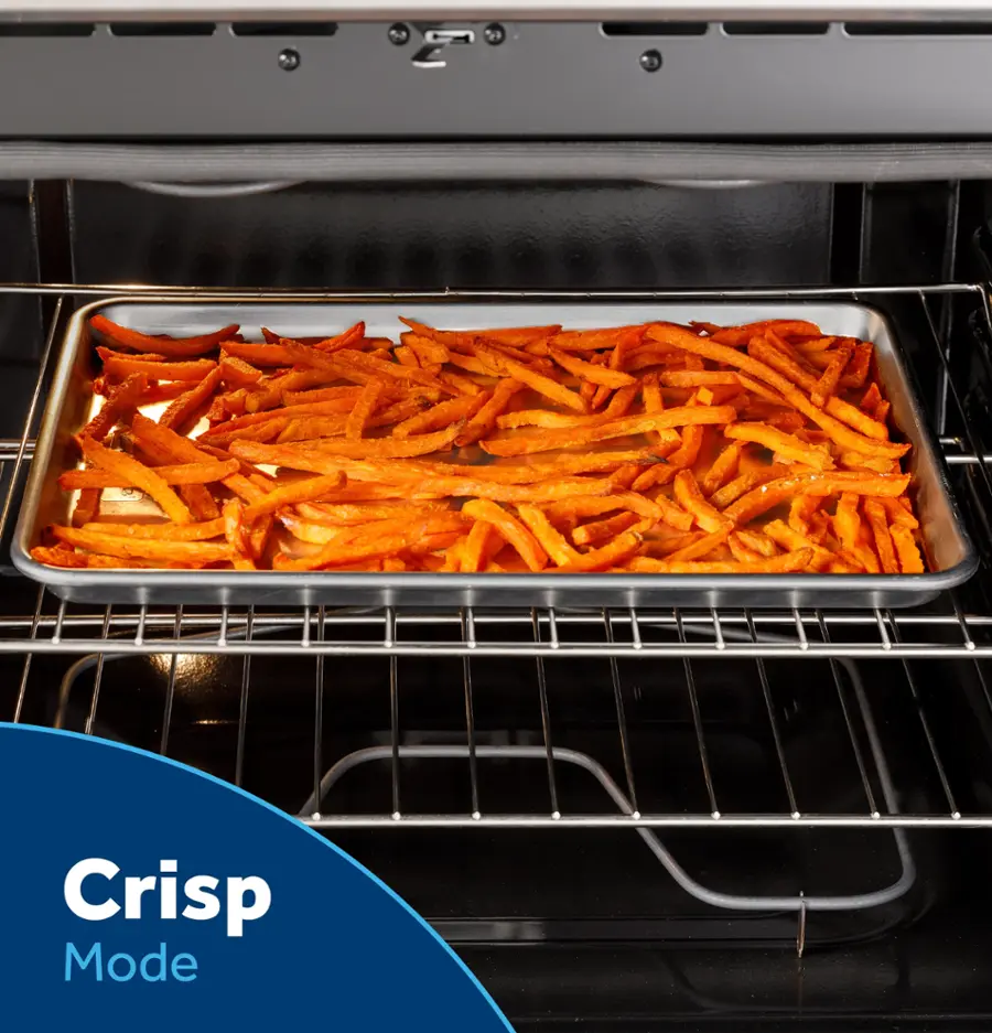 The image features a large oven with a tray of food inside, specifically a pan of fries. The oven is set to "Crisp Mode," which is a cooking setting designed to achieve a crispy texture on the food. The oven is open, allowing us to see the food inside, and the fries appear to be cooked to perfection.