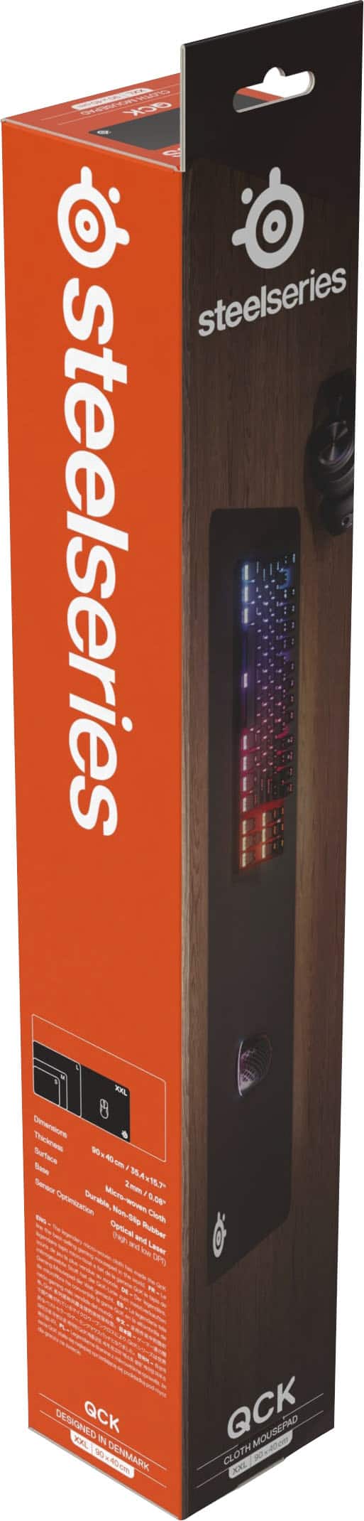 The text on the image reads: "Steelseries Steelseries XXL Dementione Surface W Bate A Seeaa 2 > Durable Mets- Mirs 6A Ceaton NonSie Ceate - Opti ~ -uies - - Lane om DESIGNED QCK DXL 1 DENMAR AC QCK MOUSEPAD CLOTH a40m KNL."