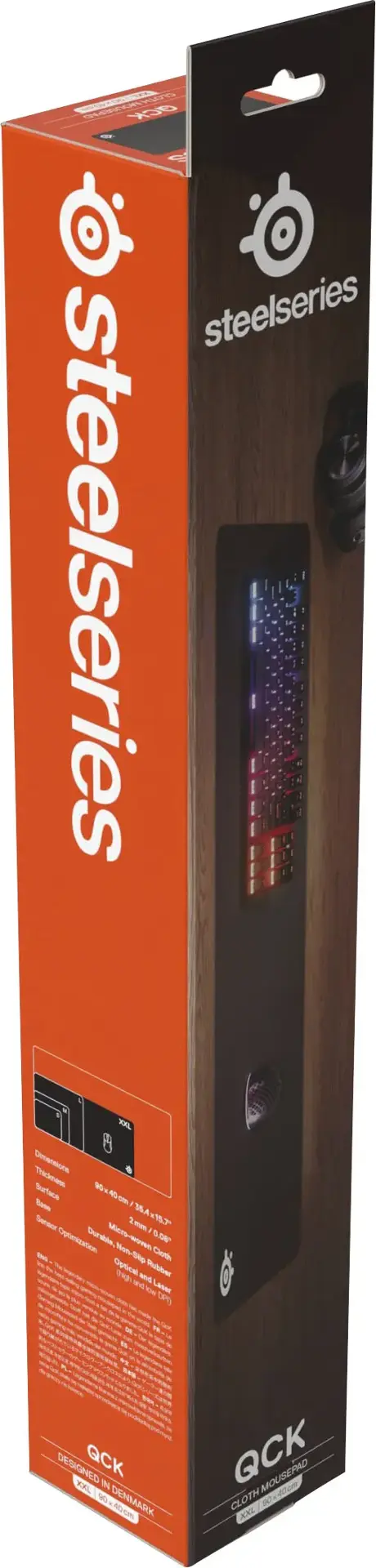 The text on the image reads: "Steelseries Steelseries XXL Dementione Surface W Bate A Seeaa 2 > Durable Mets- Mirs 6A Ceaton NonSie Ceate - Opti ~ -uies - - Lane om  DESIGNED QCK DXL  1 DENMAR AC QCK MOUSEPAD CLOTH a40m KNL."