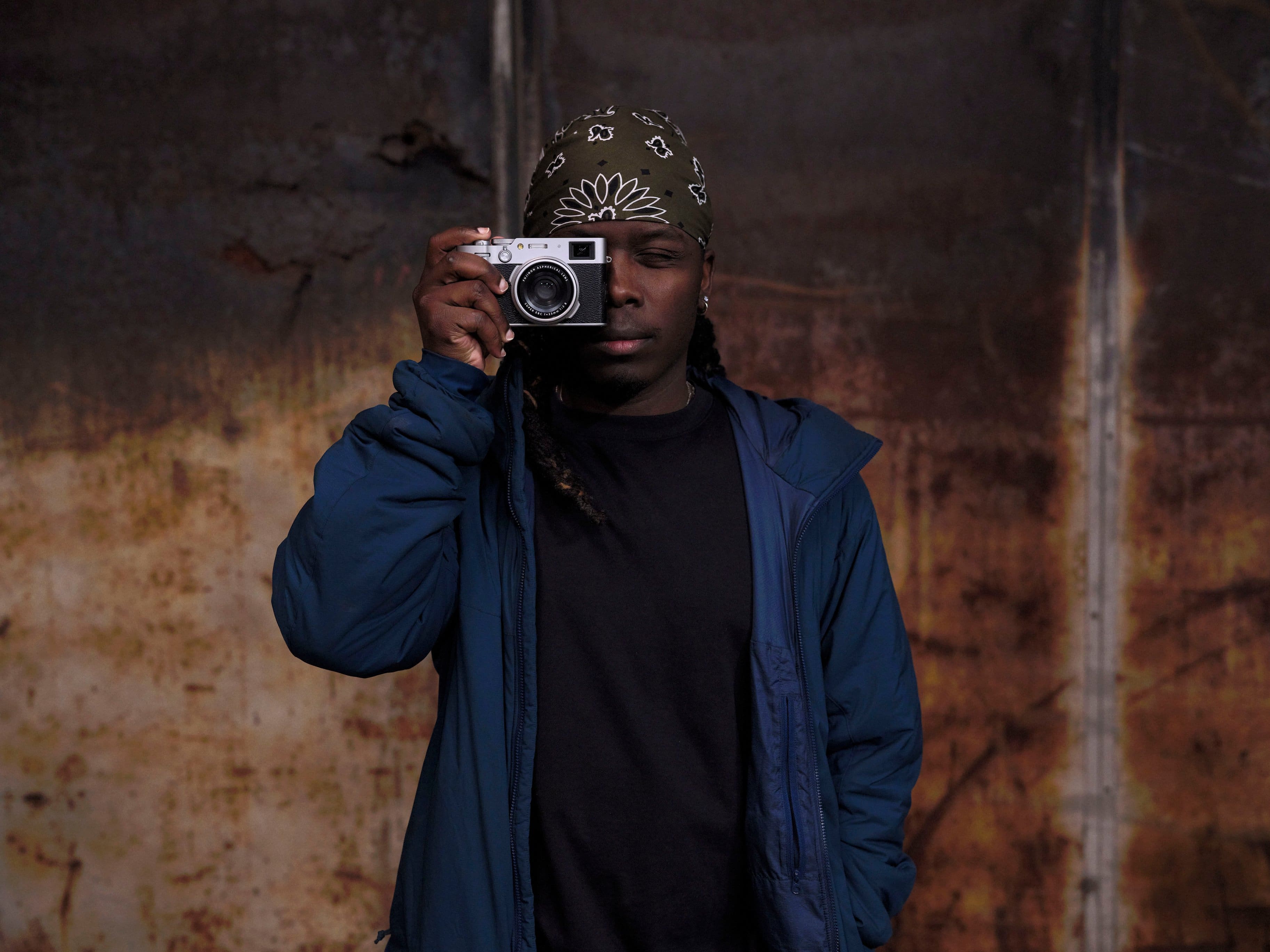 A man is holding a camera in his hand.