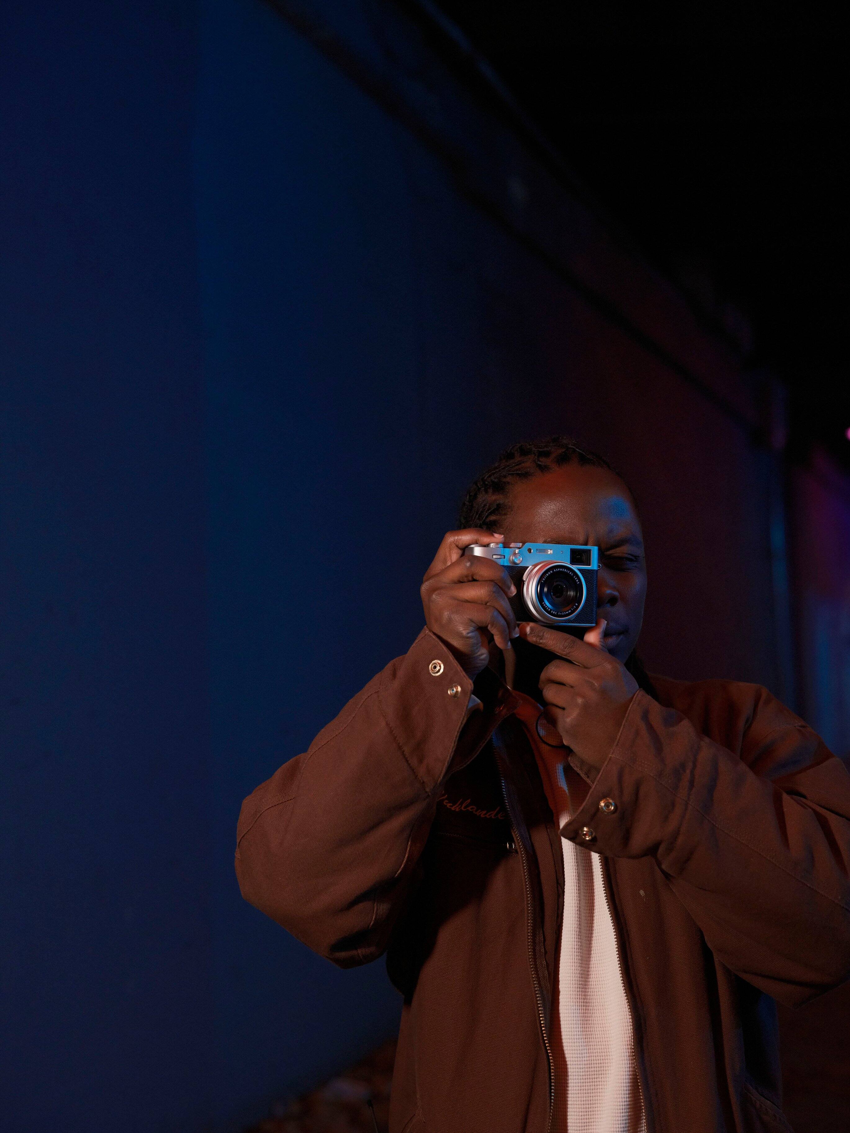 A man is taking a picture with a camera.