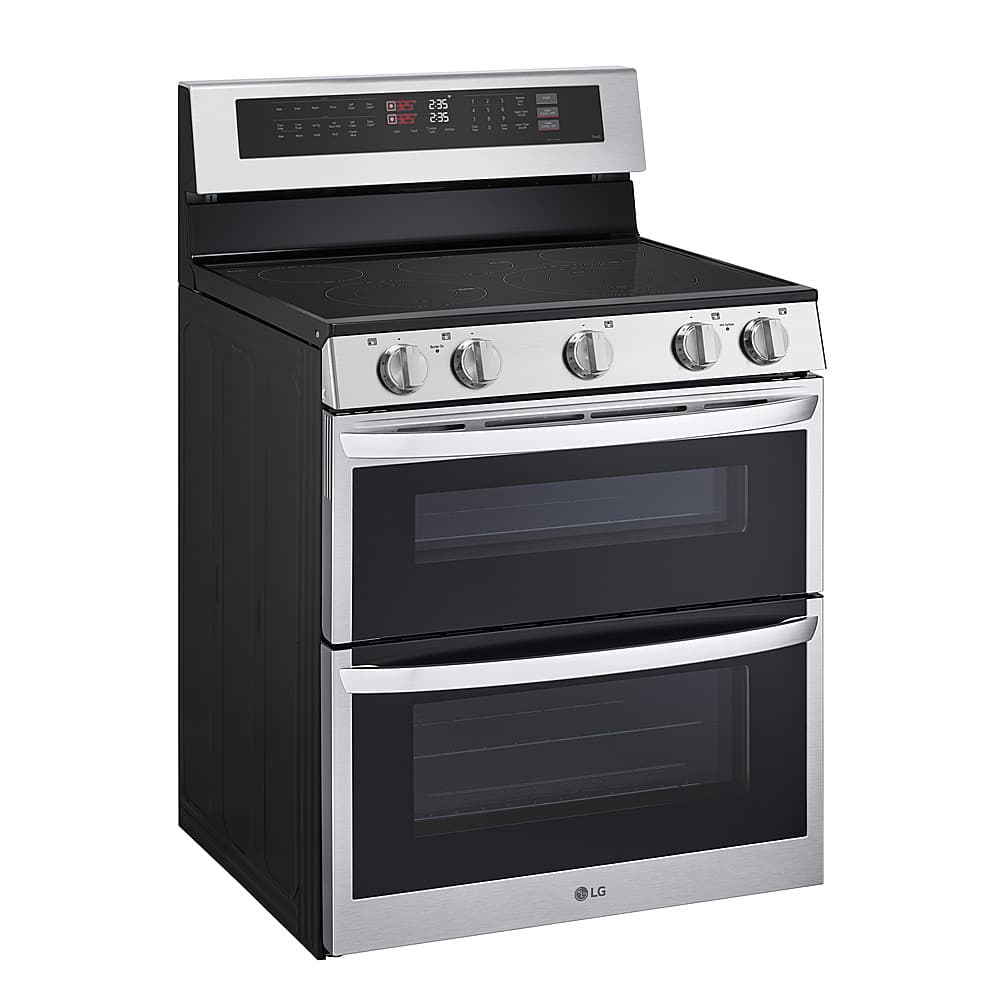 The image features a black and silver LG oven with a stainless steel finish. The oven has a digital display and a timer, making it a modern and functional appliance. The oven is positioned against a white background, which highlights its sleek design and clean appearance.