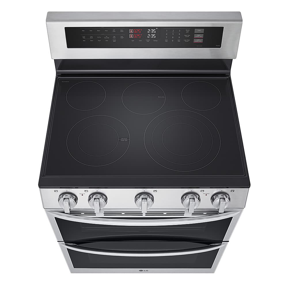 The image features a stainless steel oven with a black stove top. The oven has a digital display, which shows the time and temperature. The time displayed is 2:35, and the temperature is set at 325 degrees. The oven is open, revealing the stove top and the digital display.