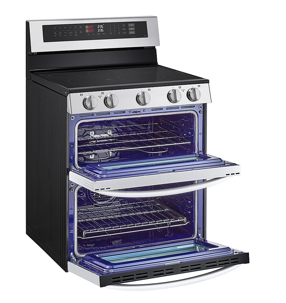 The image features a large black and silver oven with a blue interior. The oven has a stove top and an oven compartment with a blue interior. The oven is open, revealing the blue interior. The oven is likely a modern and high-quality appliance.