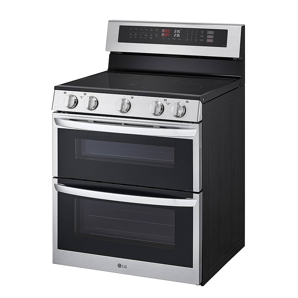 The image features a stainless steel LG oven with a black door. The oven has a digital display and a timer, indicating that it is a modern and sophisticated appliance. The oven is equipped with a stove top and a stove, making it a versatile and functional kitchen appliance. The oven is designed to provide both cooking and baking capabilities, making it a valuable addition to any kitchen.