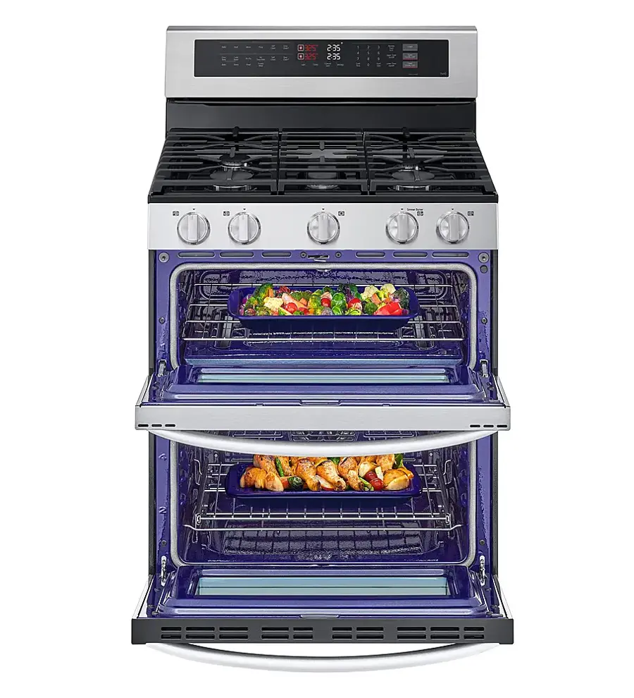 The image features a stainless steel oven with two trays of food cooking inside. The oven has a blue interior, and it is filled with various dishes, including broccoli and carrots. The oven is placed on a stove, and it is surrounded by a white background. The oven is a 9x5 model, and it has a capacity of 235.