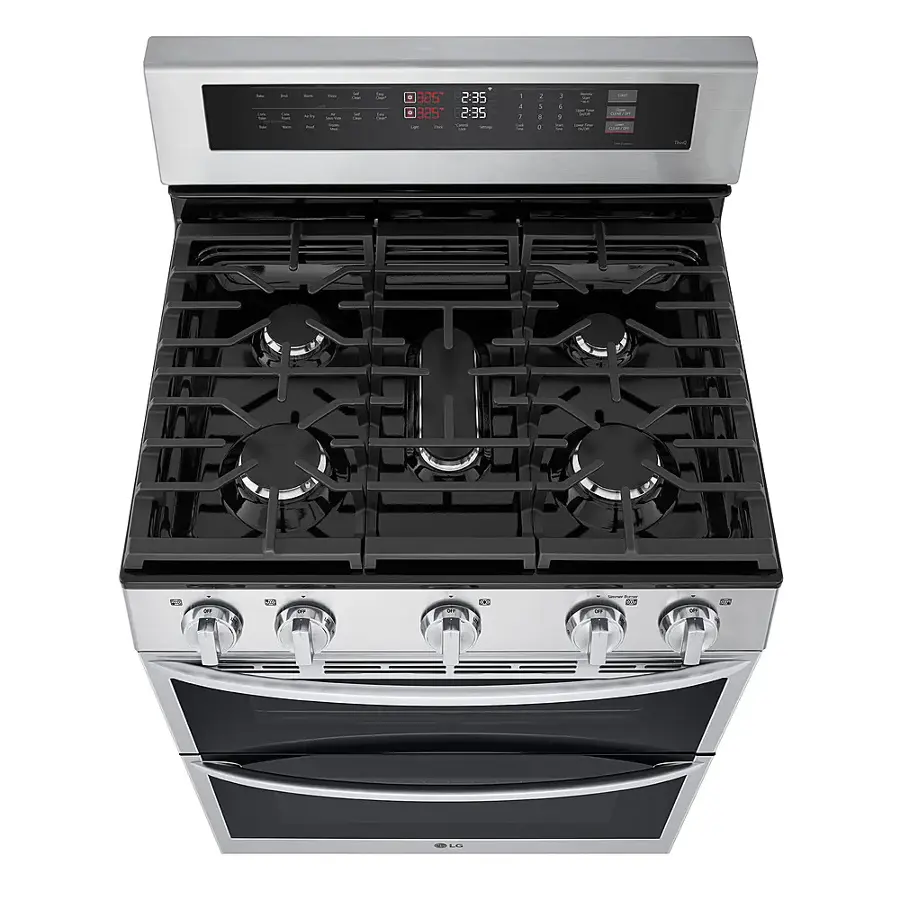The image shows a stainless steel stove with a digital clock on the front. The clock displays the time as 2:35. The stove has four burners, with one of them being the center burner. The stove is placed in a kitchen setting.